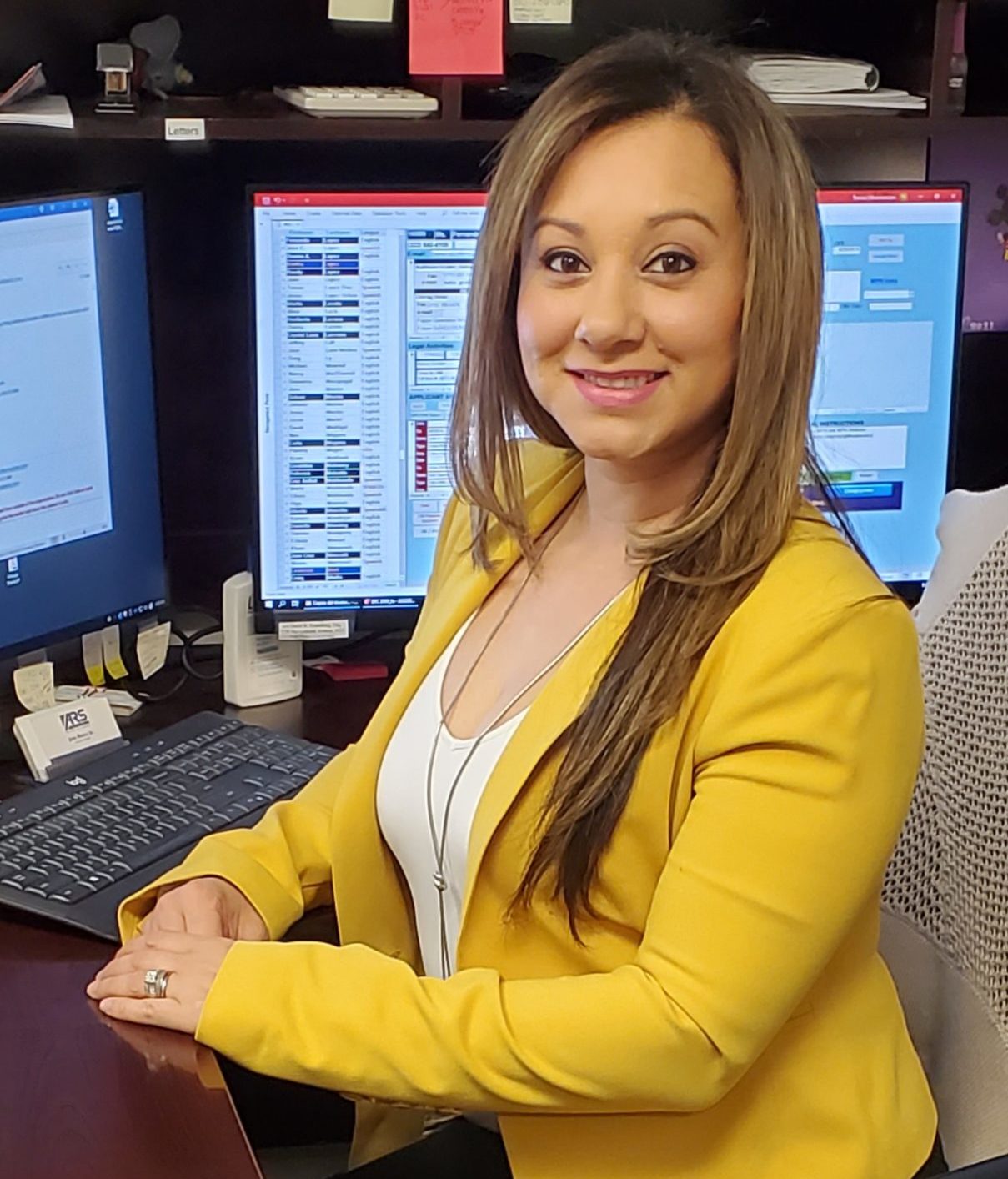 Assistant Leticia Villarreal at desk